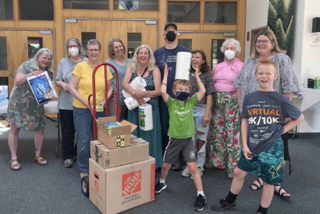 Volunteers compile kits with housewares at Dungeness Valley Lutheran Church for Ukrainian refugees now in Washington. (Photo courtesy of Dungeness Valley Lutheran Church)