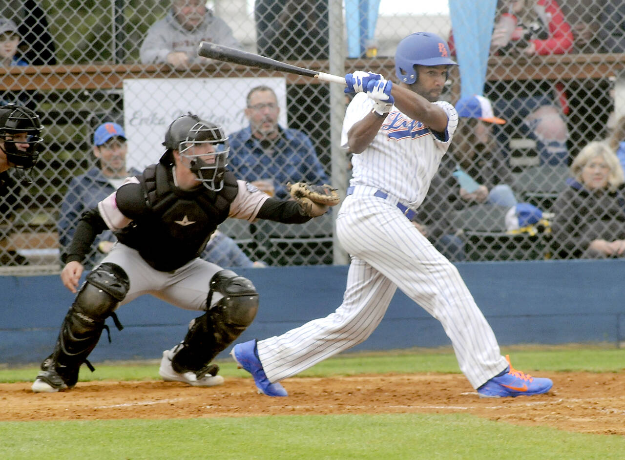 Lefties’ Golden Tate hits into an RBI double as Bend catcher Isah Burk looks on during a game in June at Port Angeles Civic Field. (Keith Thorpe/Peninsula Daily News)