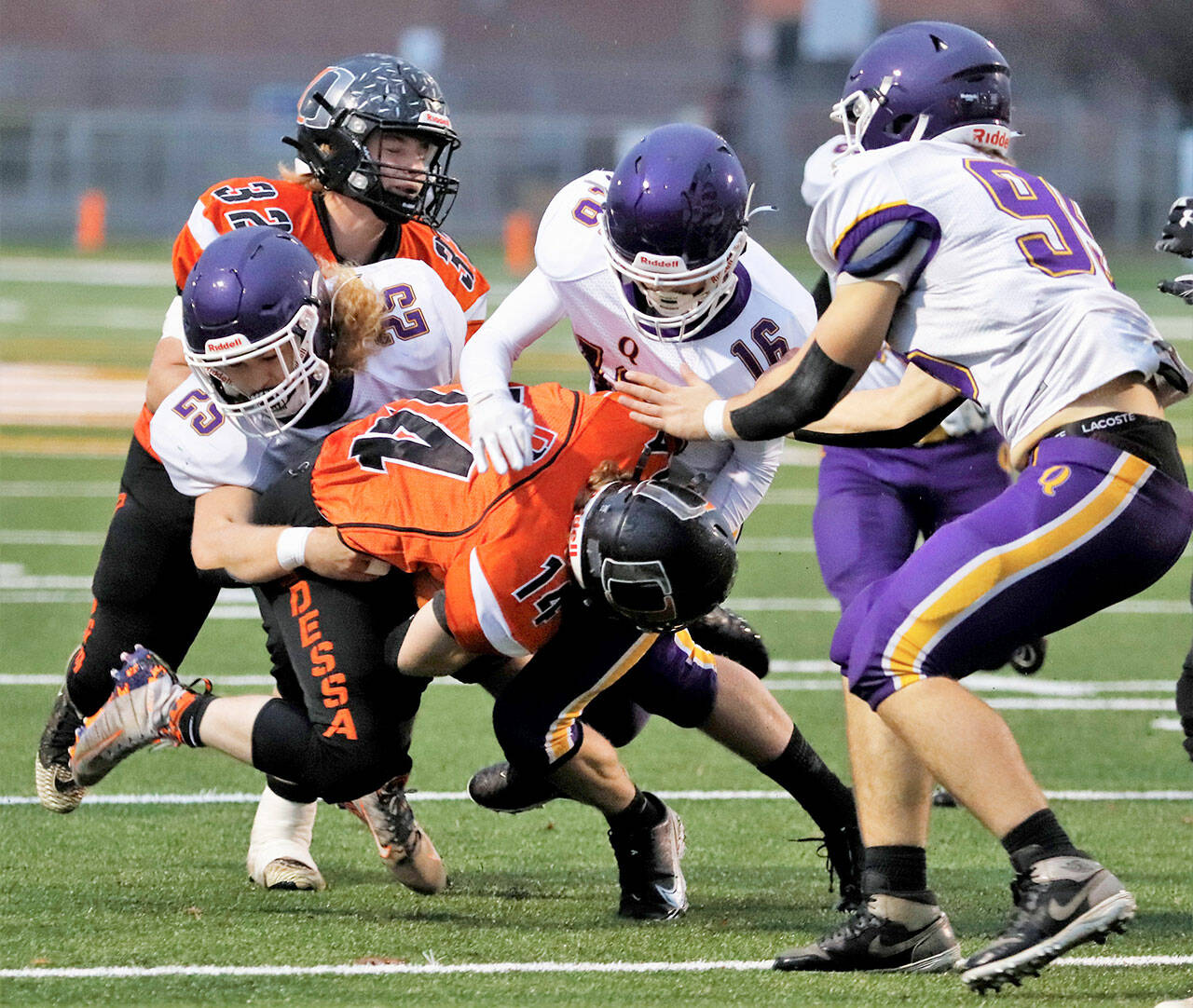 Quilcene’s, from left, Ashton Johnston, Isaiah Reimann and Deakon Budnek corral an Odessa runner during the Rangers’ state semifinal win in 2021. (Roger Harnack/Cheney Free Press)