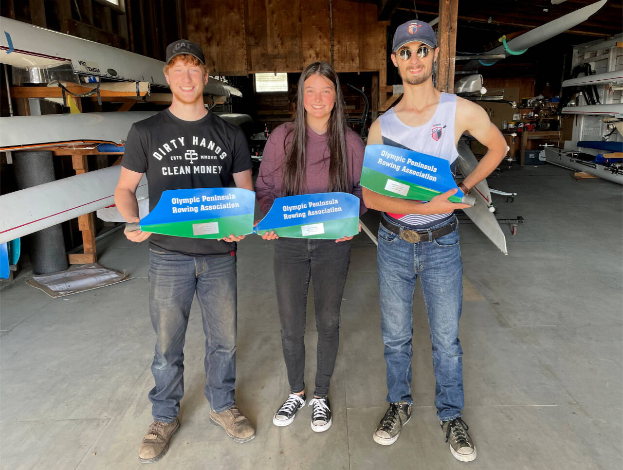 Zach Gavin, Ella Ventura and Harrison Fulton received their “graduation blades” from the Olympic Peninsula Rowing Association last week. (Courtesy photo)