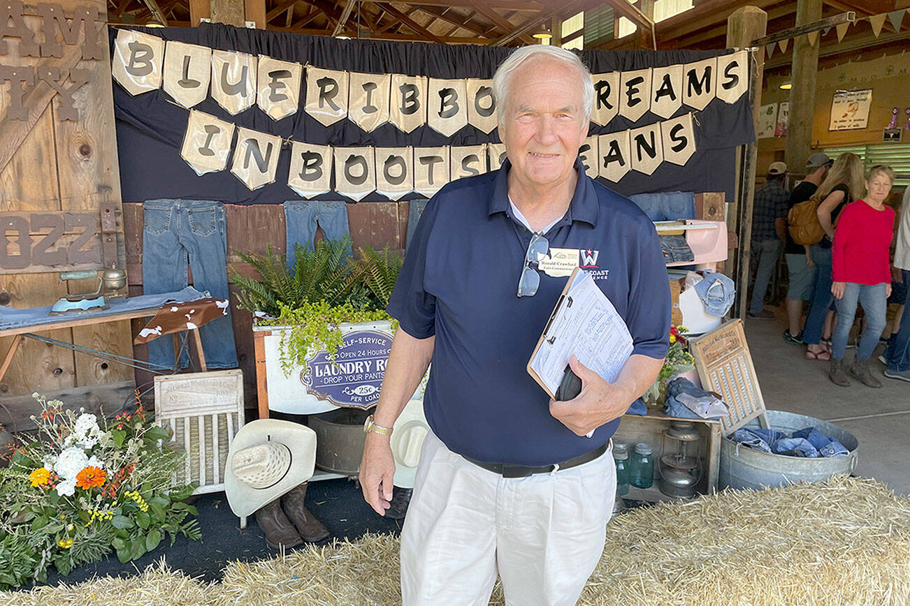 Ron Crawford, one of seven Washington State Fair commissioners, visited the Clallam County Fair on Saturday to evaluate it in a wide range of categories from the quality of its livestock and agricultural exhibits to cleanliness to the education value of displays. (Paula Hunt/Peninsula Daily News)