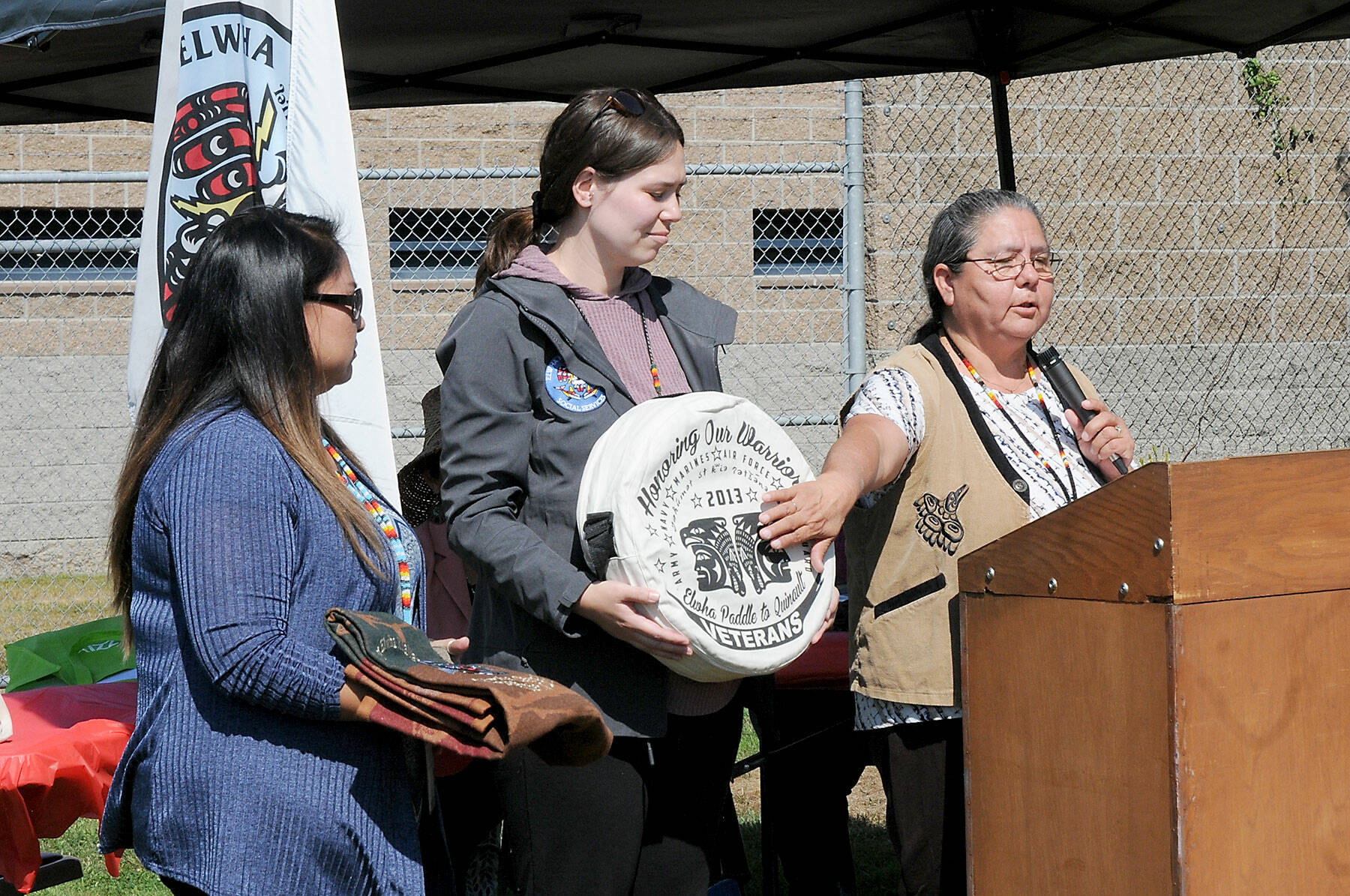 Frances Charles, chairwoman of the Lower Elwha Klallanm Tribe, right, talks about items representaing native heritage as tribal members Dawn Stephan, holding a Pendleton blanket, left, and Tessa Velasco, holding a drum, listen in during a kick-off celebration for a newly-established Indian Child Welfare Court on Wednesday at the Clallam County Juvenile Services Center in Port Angeles. (Keith Thorpe/Peninsula Daily News)