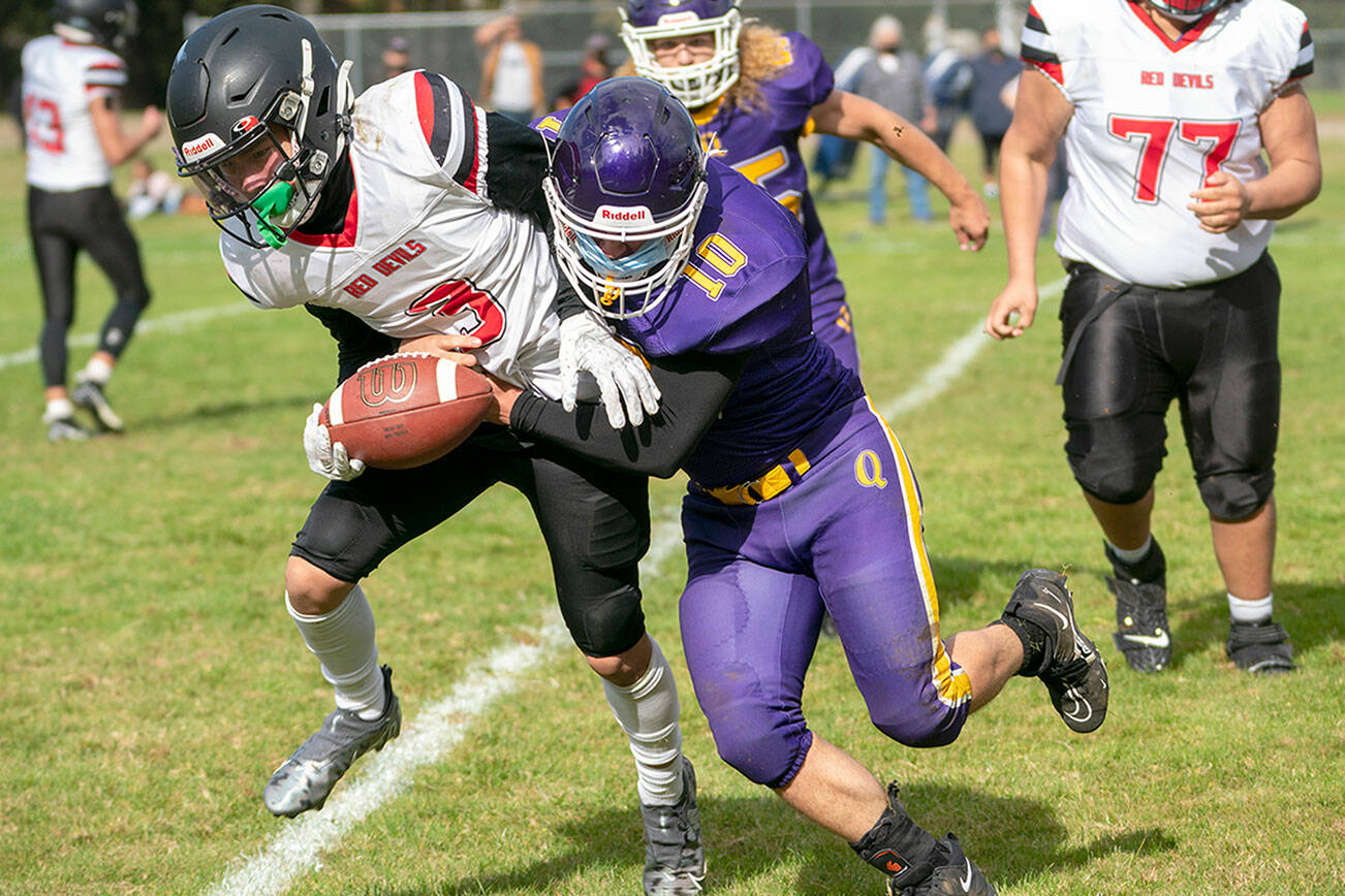 Steve Mullensky/for Peninsula Daily News
Quilcene's James Miller, right, hauls down Neah Bay's Neil Bowechop during an October 2021 contest in Quilcene.