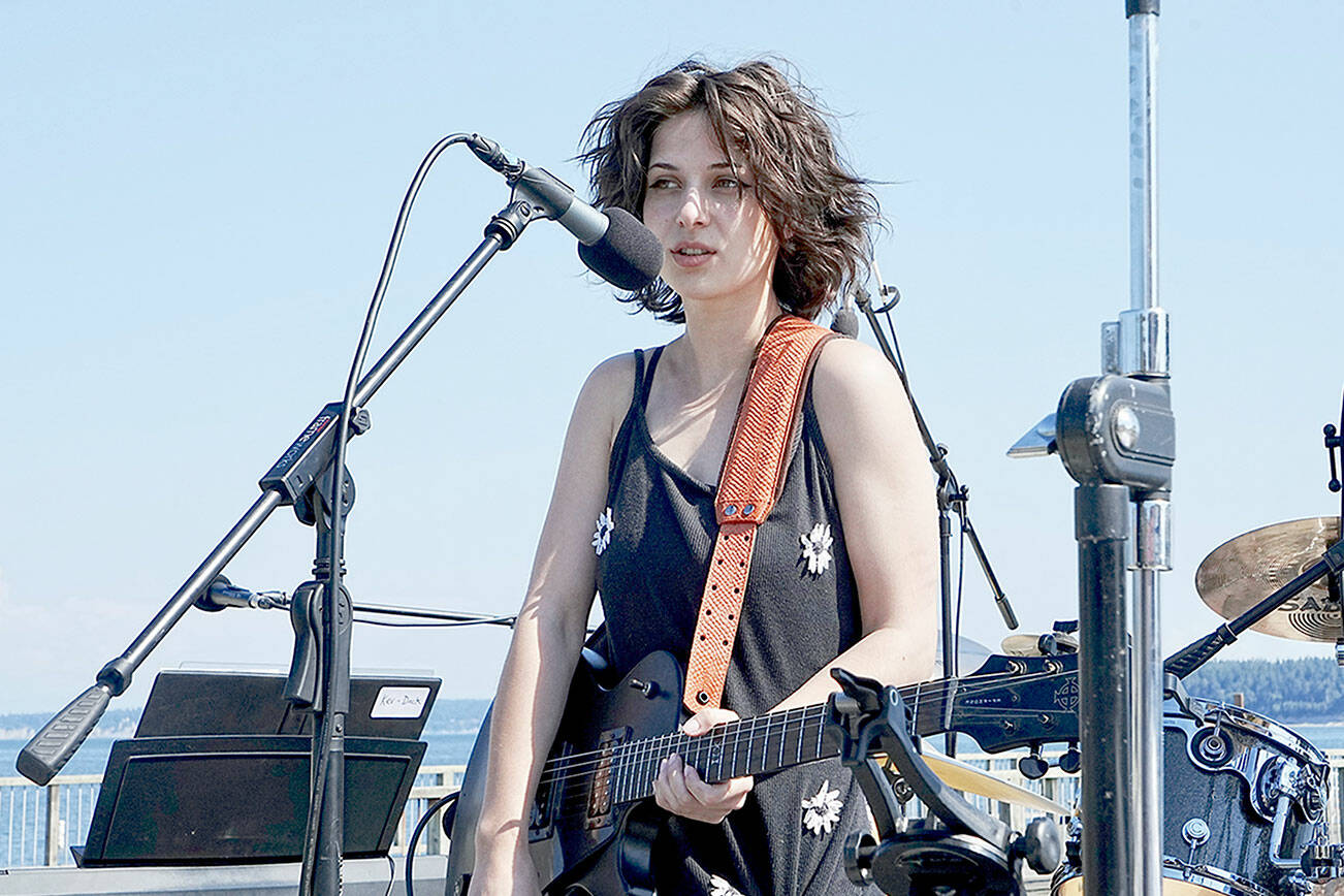Port Ludlow’s Mia Torres, 20, performs six of her original songs during the Concerts on the Dock on Thursday at Pope Marine Park in Port Townsend. The performance was part of the grand finale of free outdoor summer concerts. Port Townsend Main Street and Soundcheck joined forces, with live music beginning at 2 p.m. and continuing into the evening. (Steve Mullensky/for Peninsula Daily News)