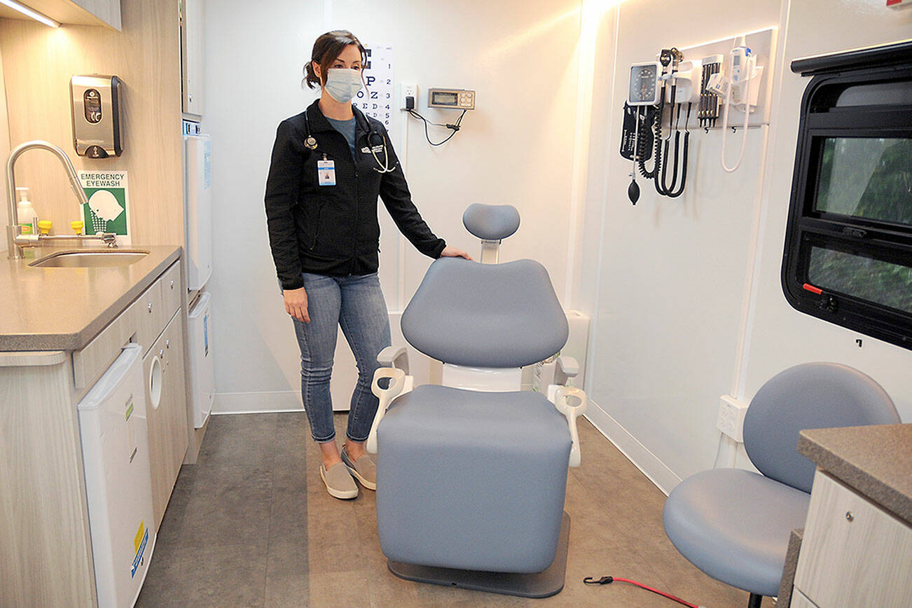 Maria Melvin, an advanced registered nurse practitioner for the North Olympic Healthcare Network, stands in the examination room of the organization’s mobile health clinic during a session at Port Angeles High School. (Keith Thorpe/Peninsula Daily News)