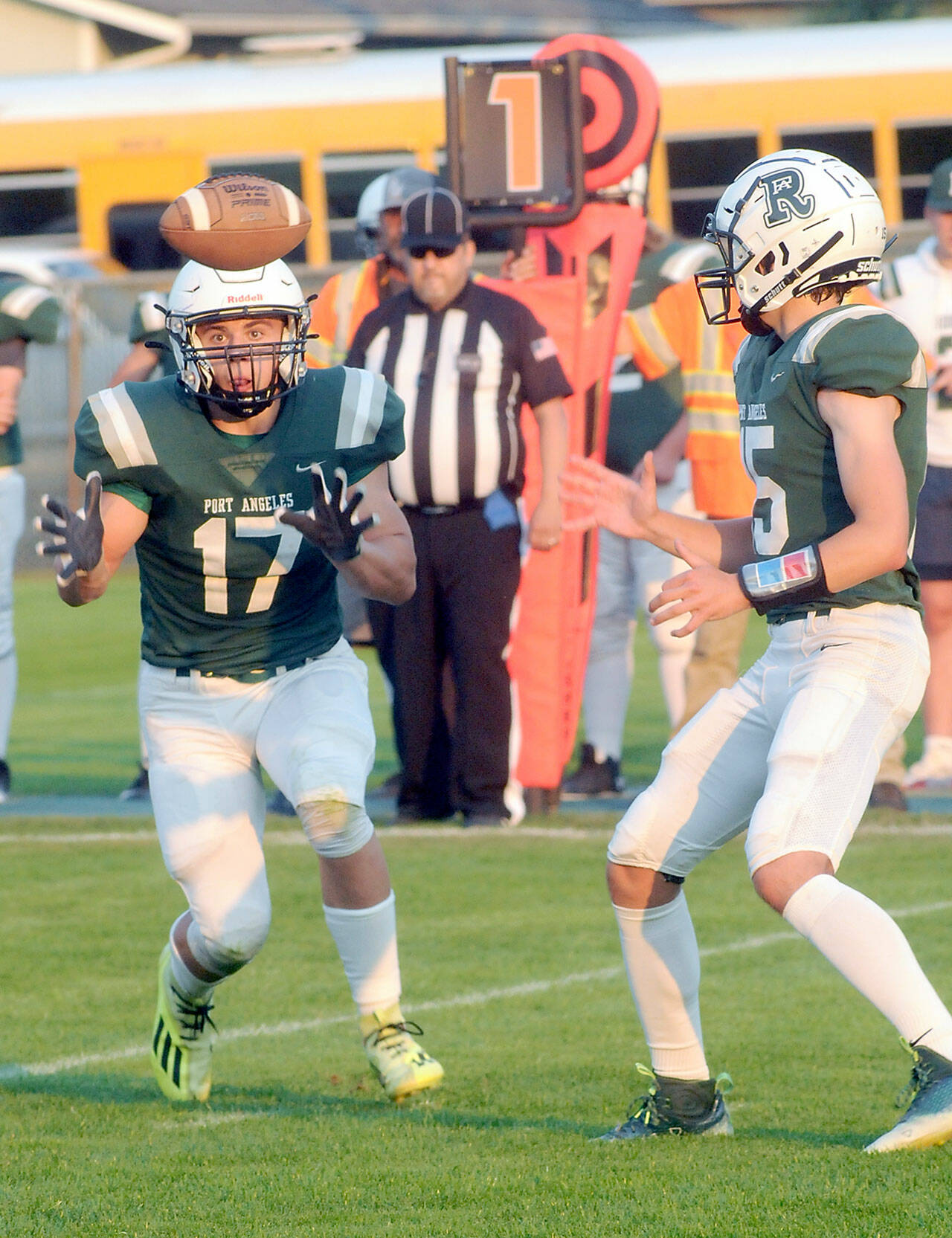 Port Angeles’ Jason Hawes, left, takes a backfield toss from quarterback Parker Nickerson during Friday night’s game against Anacortes at Port Angeles Civic Field. (Keith Thorpe/Peninsula Daily News)