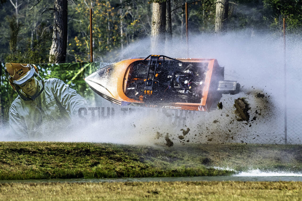 Driver Kyle Patrick and navigator Darryn Todd, the 151 Psycho unlimited class boat go flying into a fence at the Extreme Sports Park outside of Port Angeles this weekend during the second running of the American Spring Boat races. Both driver and navigator were uninjured and returned to race in the finals. (Courtesy of Wildlight Motorsport Photography)