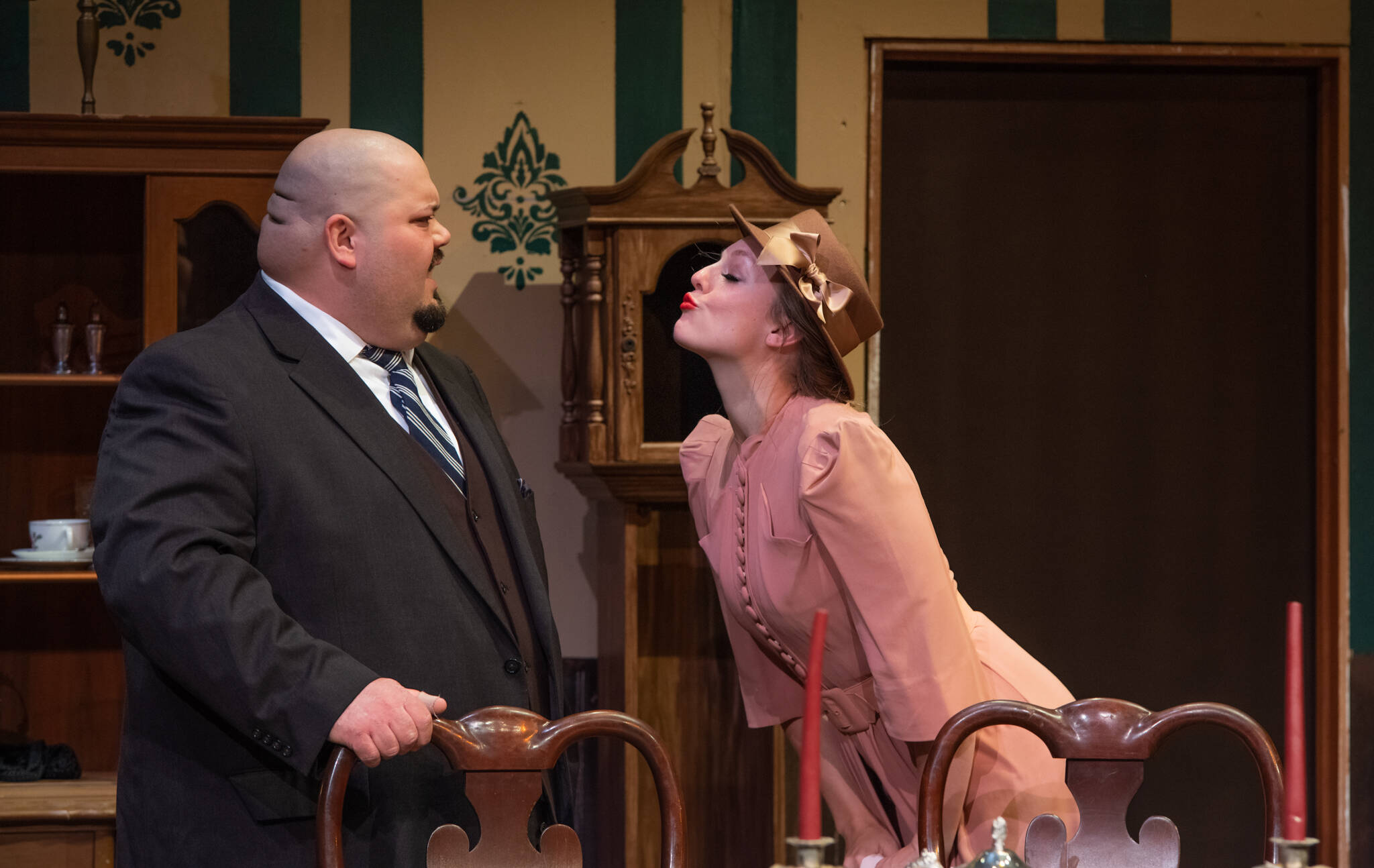 Merrin Packer as Elaine Parker leans in for a kiss from self-absorbed Mortimer Brewster, played by Mario Arruda, in Olympic Theatre Arts’ upcoming “Arsenic and Old Lace.” (Emily Matthiessen/Olympic Peninsula News Group)