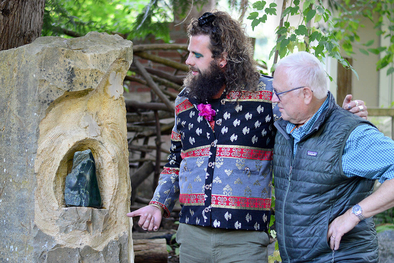 Diane Urbani de la Paz/for Peninsula Daily News
Composer Noah Michael Smith, left, and Camaraderie Cellars winemaker Don Corson admire “Spirit of Hildegard,” Corson’s sculpture in jade. Smith and Corson have collaborated on a performance celebrating Hildegard von Bingen this Saturday.