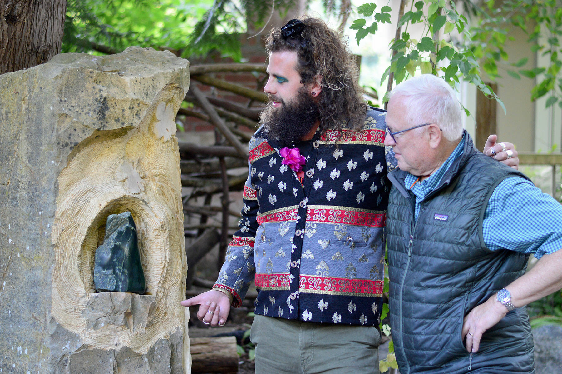 Composer Noah Michael Smith, left, and Camaraderie Cellars winemaker Don Corson admire “Spirit of Hildegard,” Corson’s sculpture in jade. Smith and Corson have collaborated on a performance celebrating Hildegard von Bingen this Saturday. (Diane Urbani de la Paz/for Peninsula Daily News)