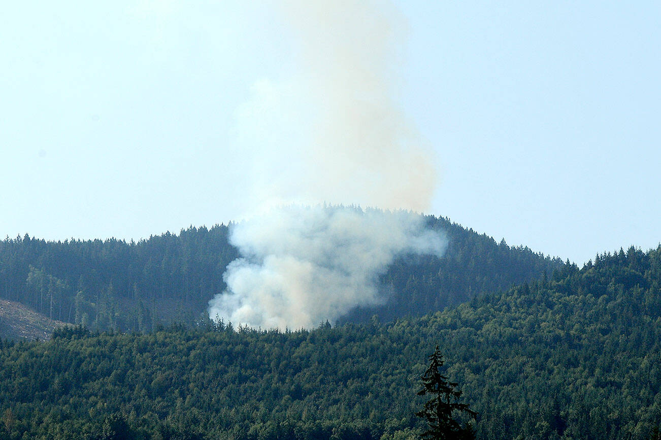 Smoke rises from a wildland fire along a side spur from Joyce Access Road east of Joyce on Thursday. (Keith Thorpe/Peninsula Daily News)
