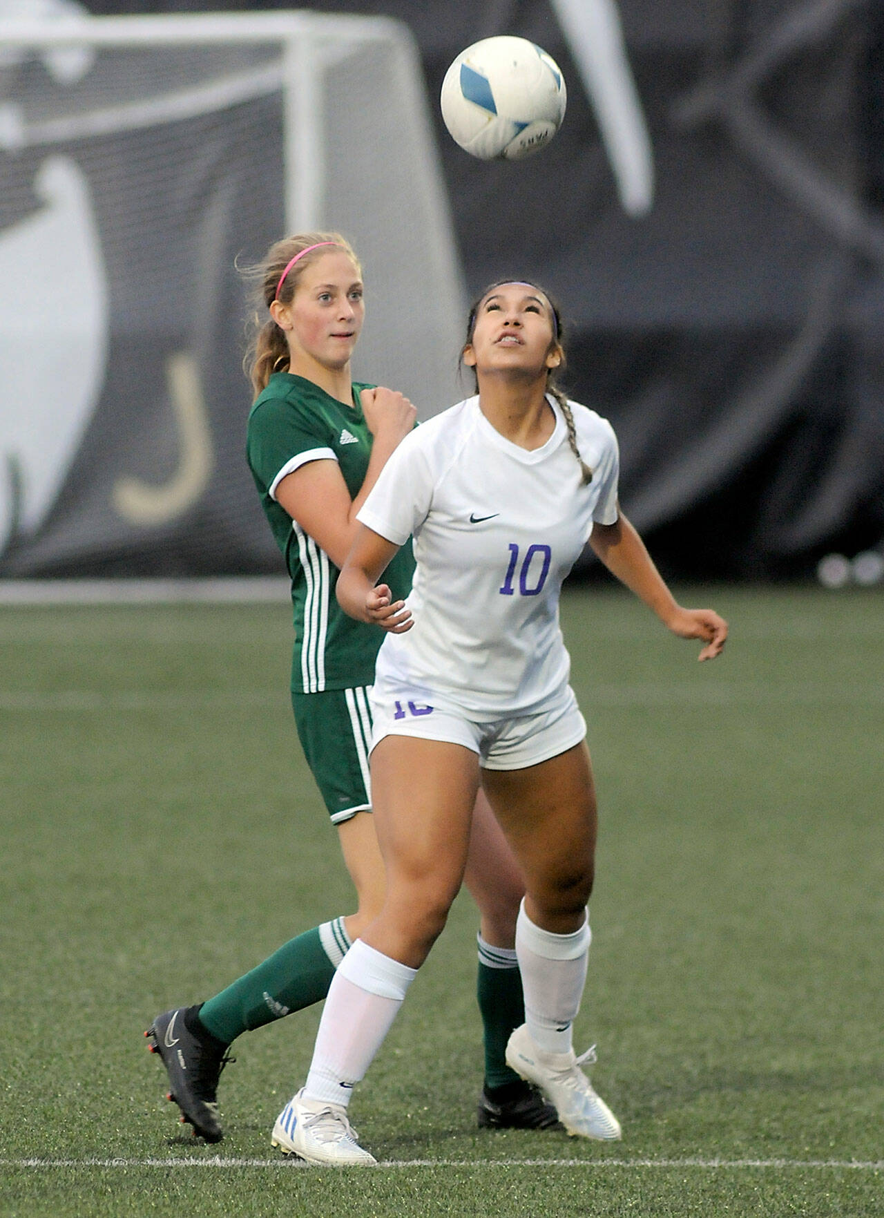 KEITH THORPE/PENINSULA DAILY NEWS Sequim’s Jennyfer Gomez, front, takes the header in front of Port Angeles’ Becca Manson on Thursday at Wally Sigmar Field in Port Angeles.