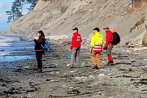 Clallam County Search and Rescue crews walk the beach at Dungeness Spit on Friday. The sheriff’s office suspects the remains found are from a seaplane crash near Whidbey Island on Sept. 4. (Clallam County Sheriff’s Office)