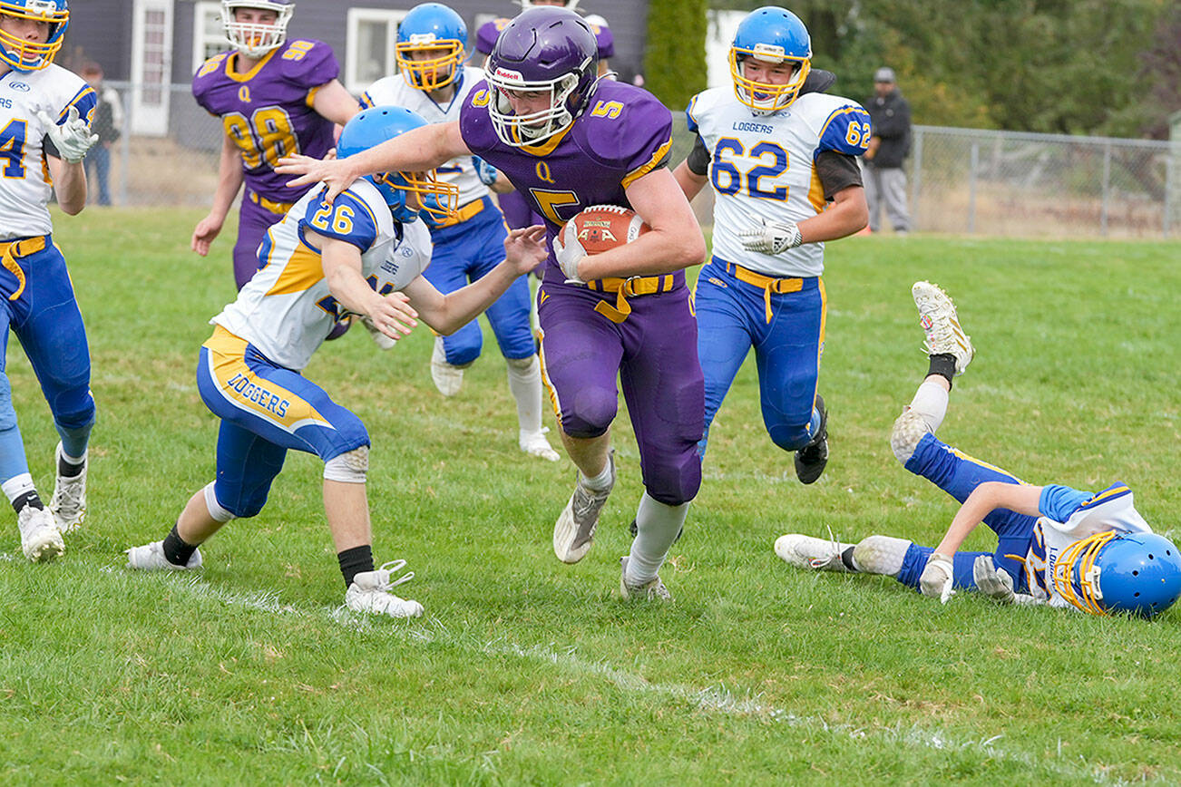 Steve Mullensky/for Peninsula Daily News
Quilcene Ranger Dominic Smith dashes around Logger Dominiq Sprague during a game in Quilcene on Saturday.