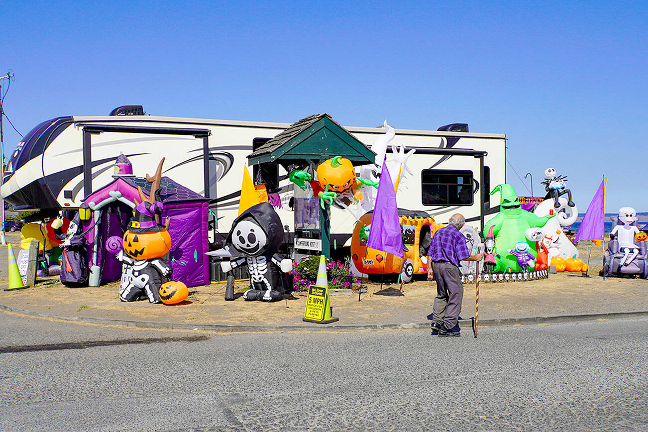 Ray Grier, a 30-year resident of Port Townsend, looks at the Halloween display set up by the park host at the entrance to the RV park at Point Hudson Marina while on his daily 2- to 3-mile walk on Tuesday afternoon. (Steve Mullensky/for Peninsula Daily News)