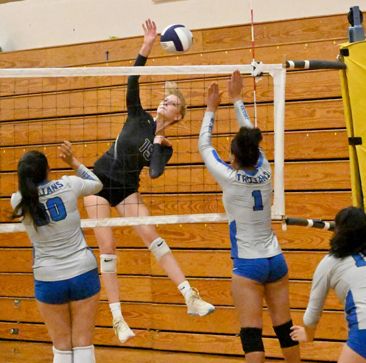 Sequim senior Kendall Hastings looks to hit past Olympic’s Erika Caryharius, left, and Aviyah Blackwell in a league match-up Tuesday in Sequim. (Michael Dashiell/Olympic Peninsula News Group)