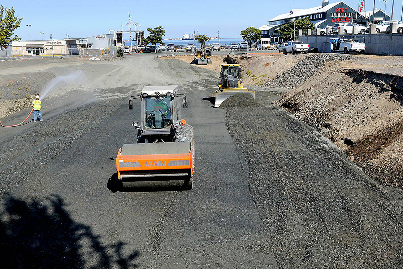 KEITH THORPE/PENINSULA DAILY NEWS
Workers move materials on Wednesday at the site of a future planned four-story, 106-room hotel being built by the Lower Elwha Klallam Tribe between First Street and Railroad Avenue at Laurel Street in downtown Port Angeles. Work resumed on the project this week after delays in the permitting process and reassessment of the hotel plans to account for inflation and other factors. Construction is expected to last from 18 to 24 months.