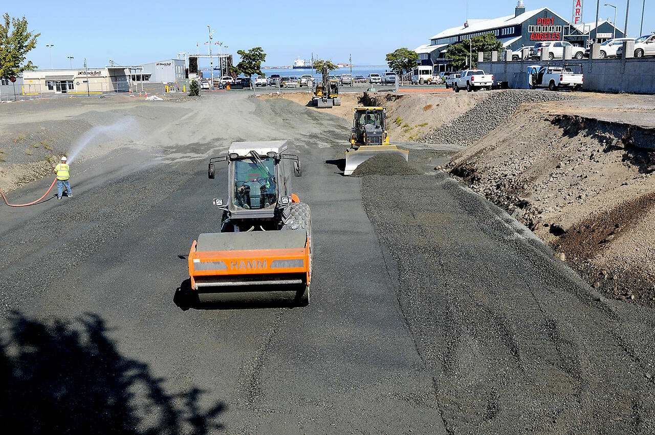 KEITH THORPE/PENINSULA DAILY NEWS
Workers move materials on Wednesday at the site of a future planned four-story, 106-room hotel being built by the Lower Elwha Klallam Tribe between First Street and Railroad Avenue at Laurel Street in downtown Port Angeles. Work resumed on the project this week after delays in the permitting process and reassessment of the hotel plans to account for inflation and other factors. Construction is expected to last from 18 to 24 months.