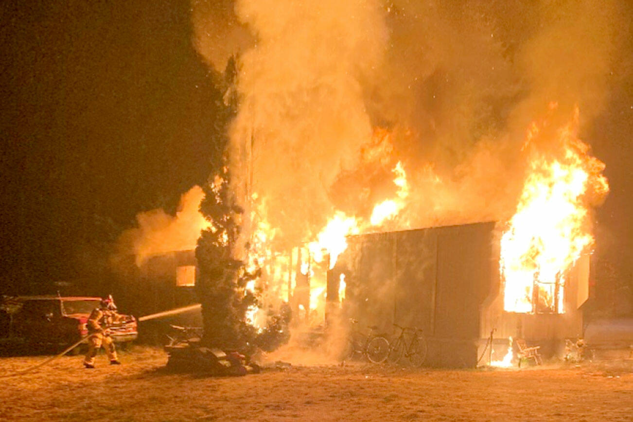 East Jefferson Fire Rescue firefighters battle a structure fire in Port Hadlock early Thursday morning. (East Jefferson Fire Rescue)