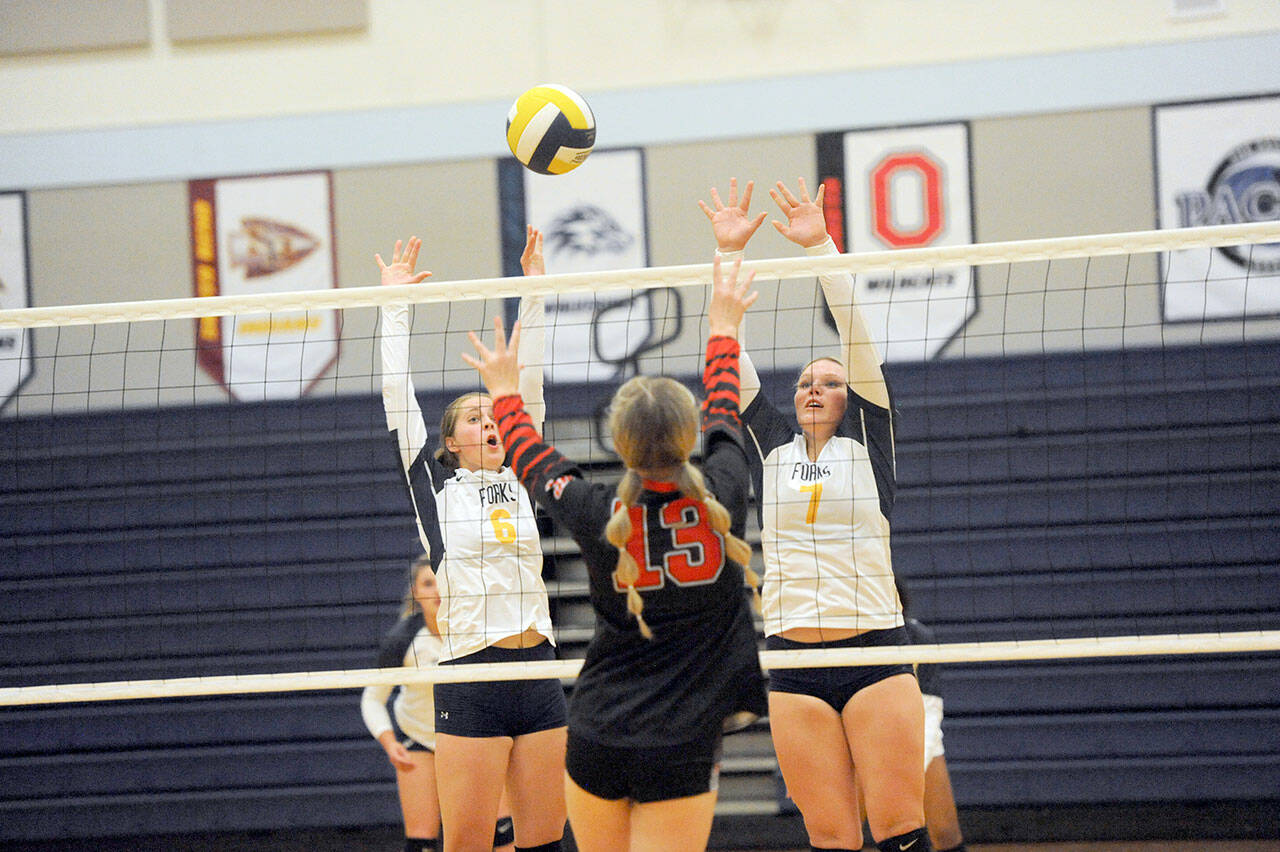 Lonnie Archibald/for Peninsula Daily News Forks’ Chloe Gaydeski-St. John, left, and Kyra Neel challenge Raymond’s Ava Baugher (center) at the net.