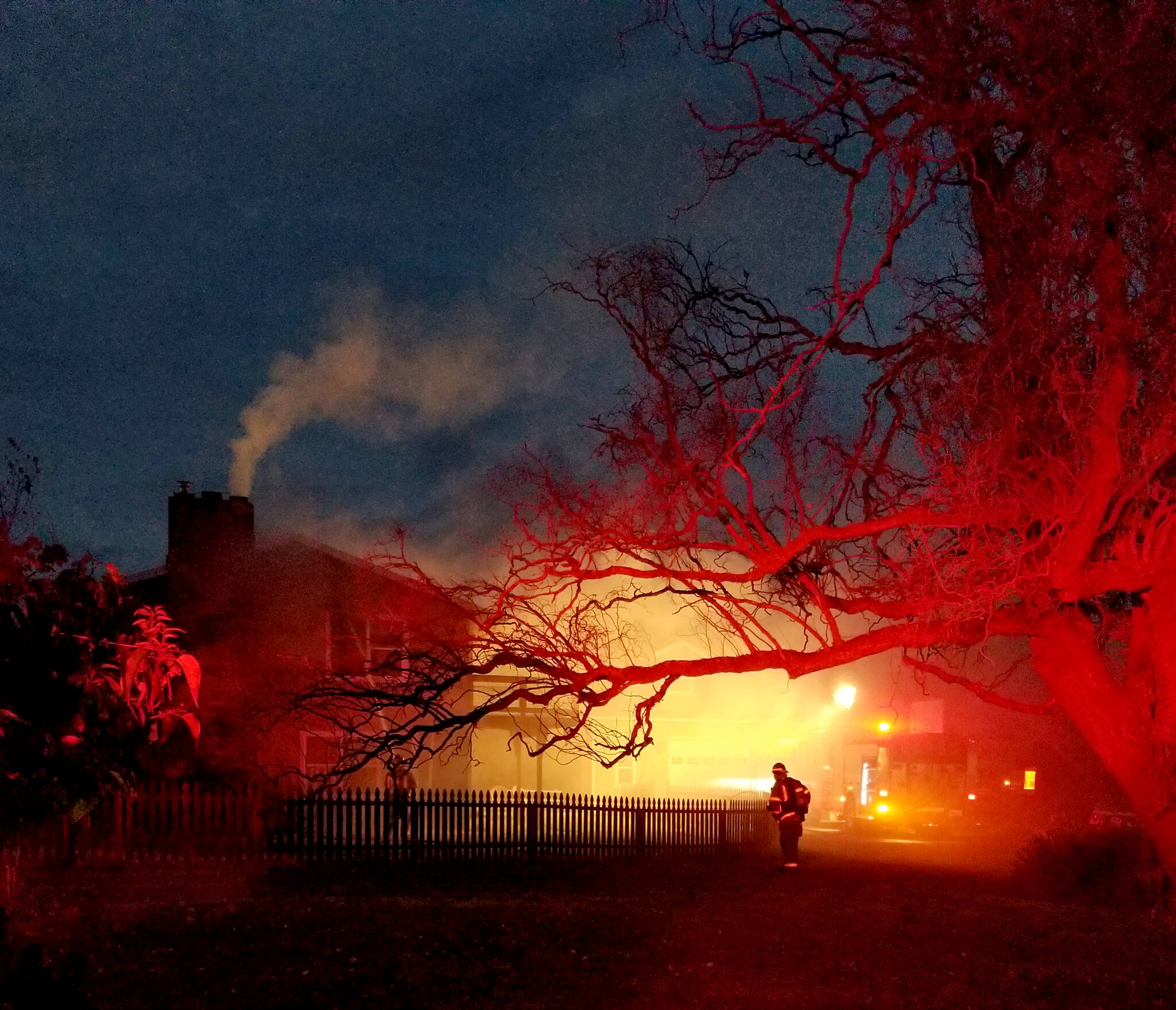 Fire District 3 firefighters battle a blaze in Sequim. (Leah Andrews/for Peninsula Daily News)