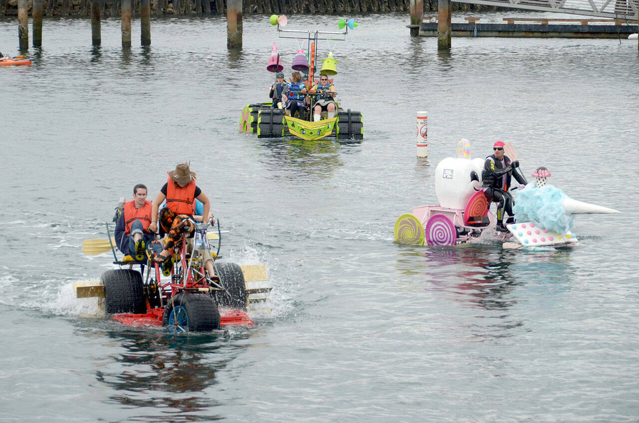 Despite the rain and cooler temperatures teams were in high spirits as they tackled the water course on day at an earlier Kinetic Skulpture Race in Port Townsend. (Peninsula Daily News)
