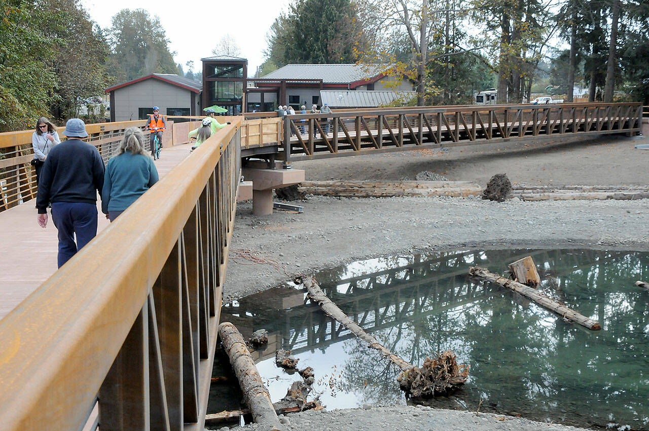 Pedestrians and bicyclists make their way arcoss a pair of new spans crossing the newly-restored flood plain of the Dungeness River at Railroad Bridge Park on Wednesday. (Keith Thorpe/Peninsula Daily News)