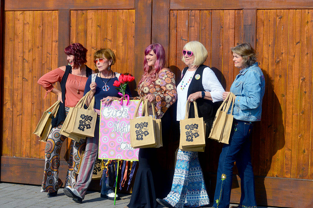 Preparing to celebrate Girls’ Night Out in downtown Port Townsend on Thursday afternoon are, from left, Holly Erickson, Lorilee Houston, Eryn Smith, Sue Arthur and Mari Mullen. After a hiatus, the Main Street Program-hosted annual event returned to distribute goodie bags, encourage women to shop local and raise funds for the Jefferson Healthcare Foundation. The foundation helps provide free breast/cervical cancer screenings for women in need. (Diane Urbani de la Paz/For Peninsula Daily News)