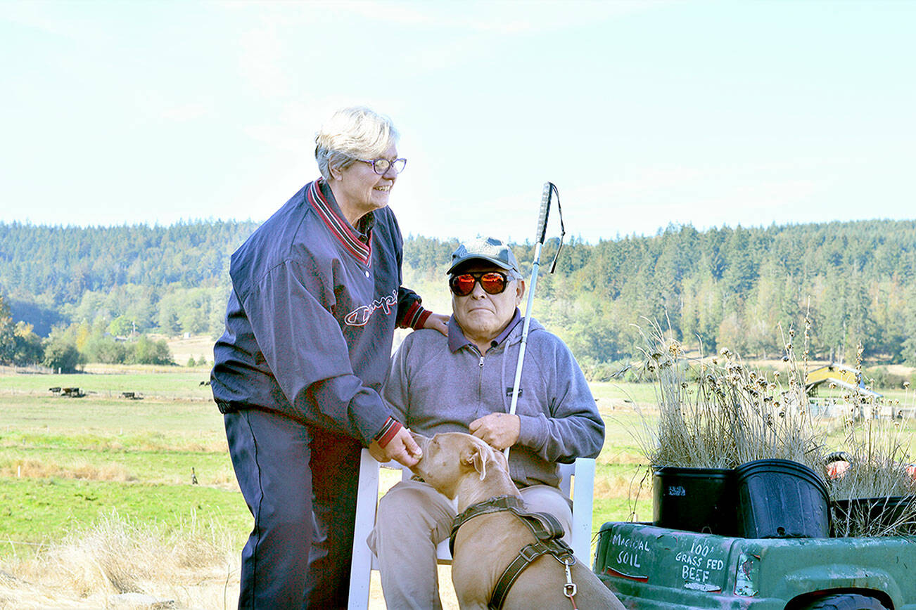 Sandy and Roger Short, along with their dog Blue, took in the sunshine at their Chimacum place Friday morning. Diane Urbani de la Paz/For Peninsula Daily News