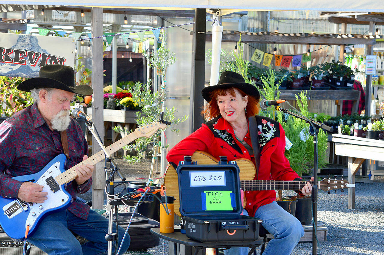 At the Sunday Chimacum Farmers Market, Jill and Kevin — aka Jill McAnally and Kevin McConell — sing country, swing and blues songs to vendors and shoppers. The produce and artisan market, outside the Chimacum Corner at 9122 Rhody Drive, will be held just two more Sundays before it wraps up for the season on Oct. 30. (Diane Urbani de la Paz/For Peninsula Daily News)