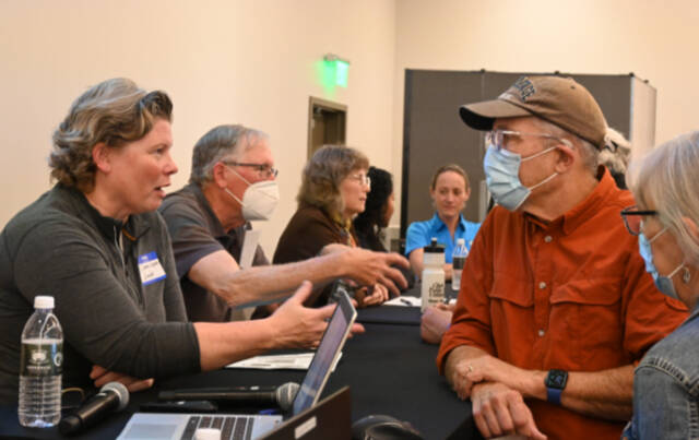 Diana Dupuis, Washington State Parks and Recreation Commission director, talks about development of the Miller Peninsula State Park property with meeting attendees following an open house in Blyn. (Michael Dashiell/Olympic Peninsula News Group)