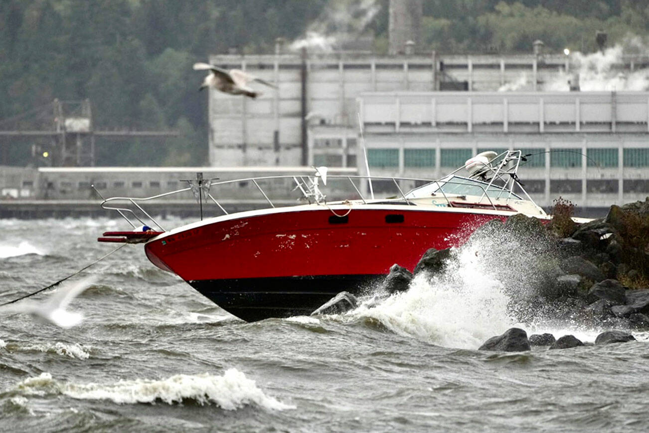 A power boat was driven onto rocks at Port Townsend Boat Haven after storm-driven winds whipped the bay into a frenzy of white caps about mid-day Tuesday. (Steve Mullensky/for Peninsula Daily News)
