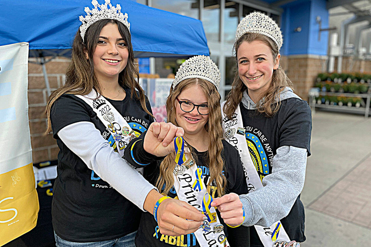 Matthew Nash/Olympic Peninsula News Group
Sequim Irrigation Festival royalty, from left, Queen Isabella Williams, Princess Lauren Willis, and Princess Katherine Gould helped promote Down yndrome Awareness Month in front of Sequim Walmart.