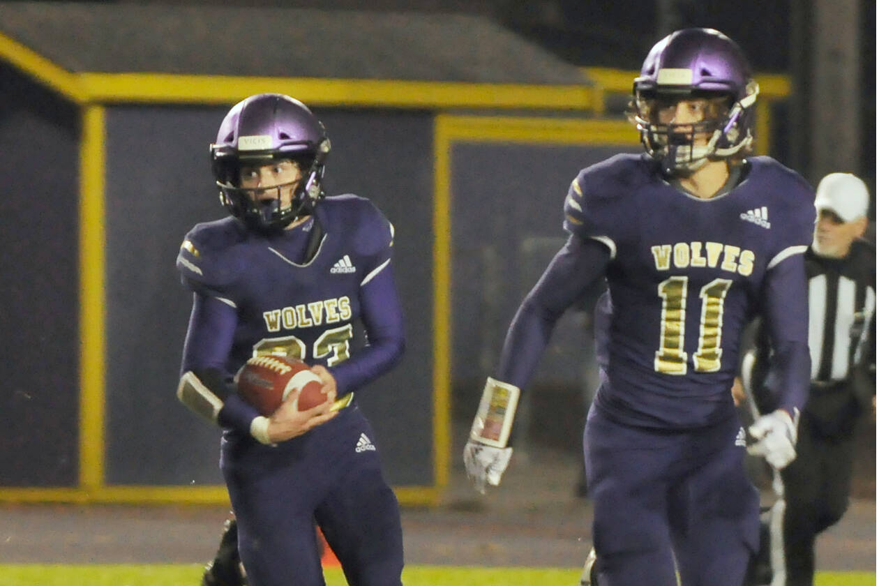 Sequim’s Sam Fitzgerald, left, looks for running room as Aiden Gockerell looks to provide a block in the Wolves’ season-finale against Bremerton on oct. 28. Fitzgerald had three first half touchdowns. (Michael Dashiell/Olympic Peninsula News Group)
