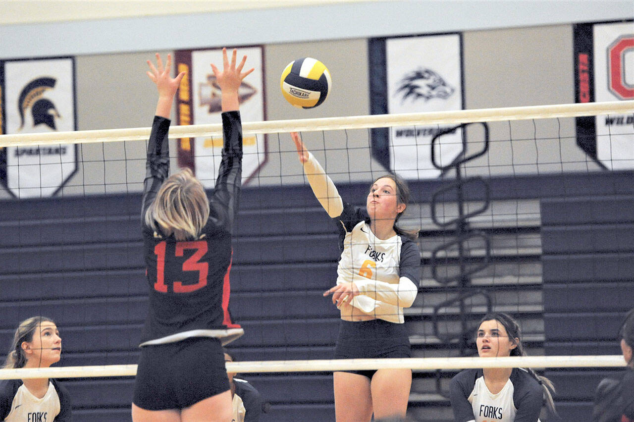 Forks’ Chloe Gaydeski-St. John (6) hits against Toledo’s Eden Jones (13) Saturday afternoon in Forks during the District IV 2B tournament. Also in the action are Forks’ Erika Williams (left) and Kaidence Rigby. Forks defeated the Riverhawks 3-1 but split on the day with a loss to Adna 3-1. Forks is still alive in the postseason and is scheduled to play Ilwaco in Ocosta at 5:30 p.m. Wednesday. (Lonnie Archibald/for Peninsula Daily News)