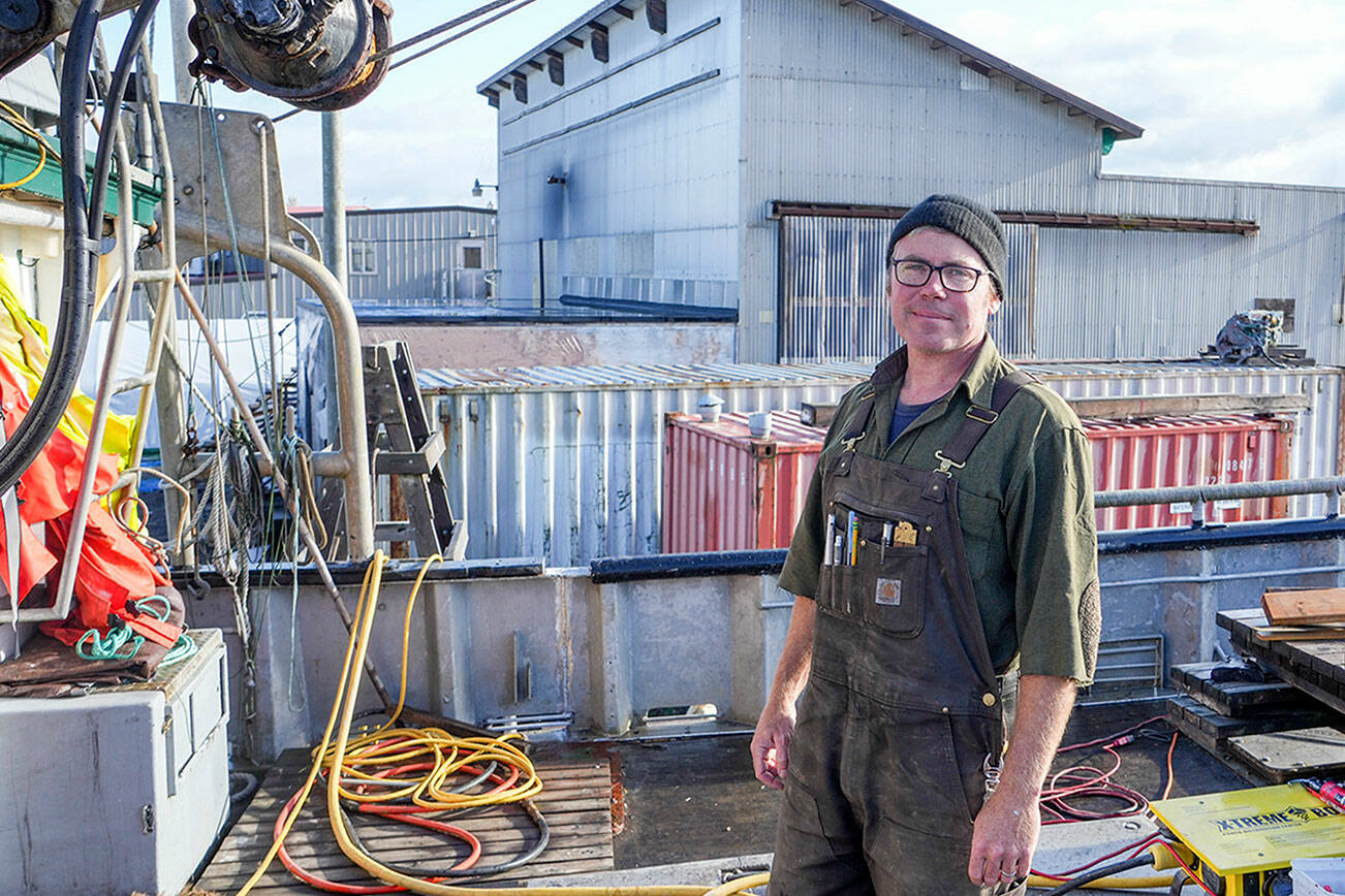 Blaise Holly, new owner of Haven Boatworks at the Boat Haven in Port Townsend, is on board the Molly, a commercial boat his company is servicing. In the background is Integrated Marine Systems, a building to which Holly will be re-locating soon. (Steve Mullensky/for Peninsula Daily News)