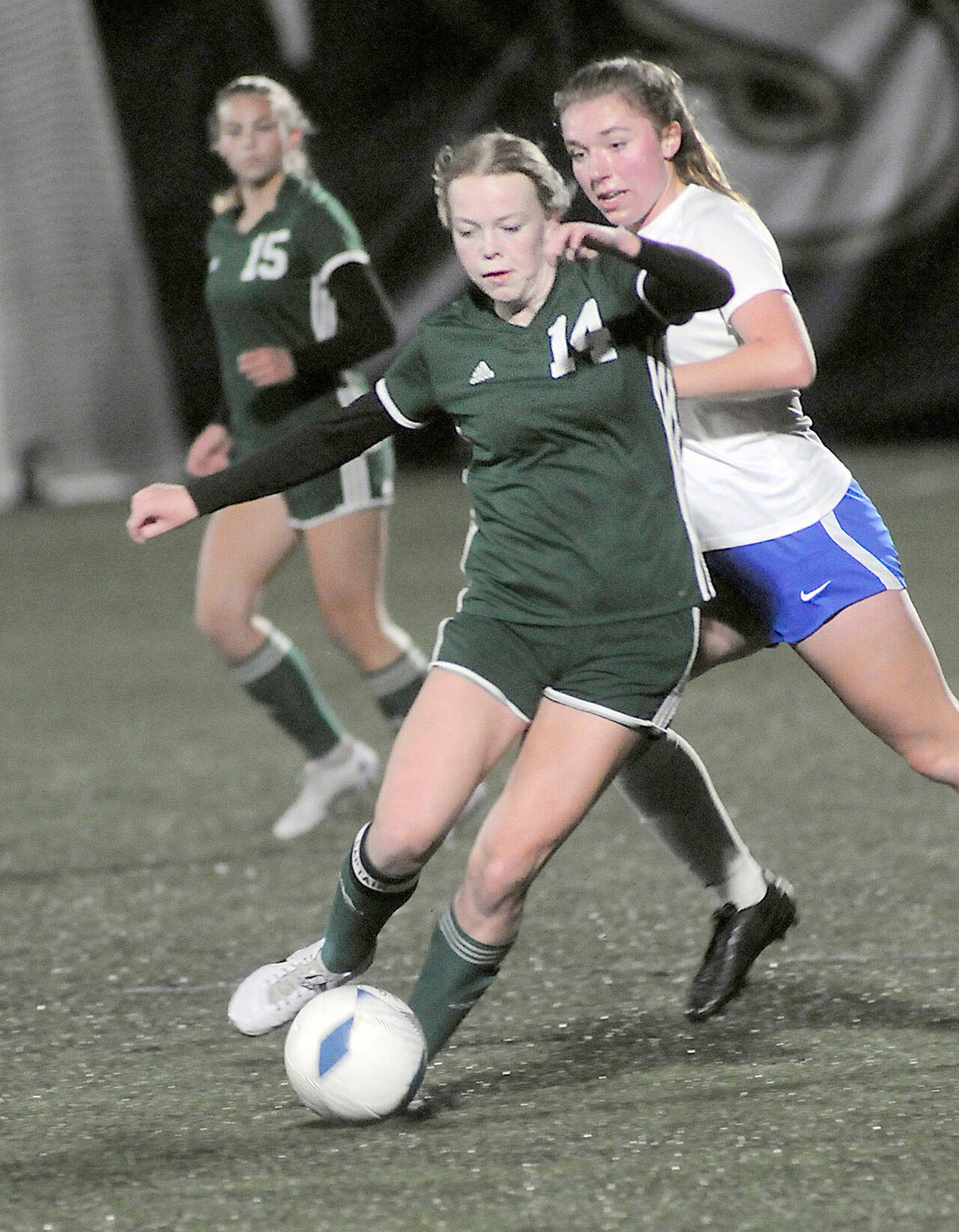 KEITH THORPE/PENINSULA DAILY NEWS Port Angeles’ Anna Petty, front, weaves around the defense of Bremerton’s Claire Warthen as Petty’s teammate, Kennedy Rognlien looks on from behind on Wednesday at Wally Sigmar Field in Port Angeles.