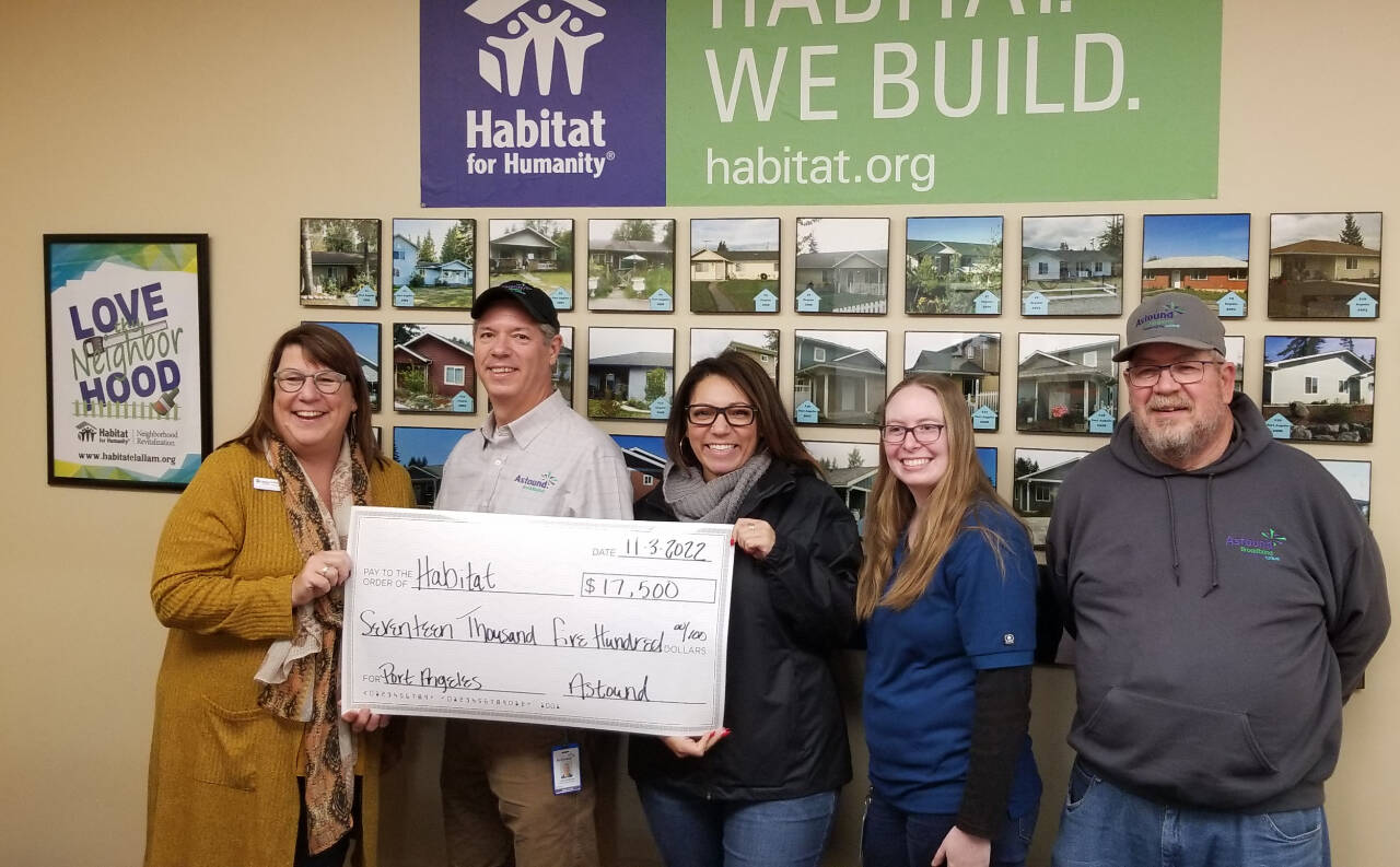 From left, Colleen Robinson, CEO of Habitat for Humanity of Clallam County, accepts a $17,500 grant from Astound Broadband Powered by Wave staffers Jake Crabtree, Tracy Vann, Sierra Wilkens and Guy Eyraud. (Photo courtesy of Astound Broadband Powered by Wave)