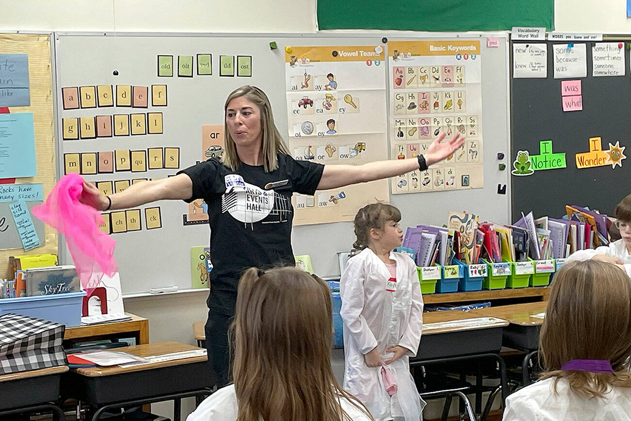Dancer Keely Whitmore leads second graders in teacher Sharon Fritschler's class at Roosevelt Elementary in exercises that integrate movement and a science lesson about geology as part of Peninsula Performs, a collaboration between Field Arts & Events Hall and the Port Angeles School District that brings artist educators into classrooms. (Paula Hunt/Peninsula Daily News)
