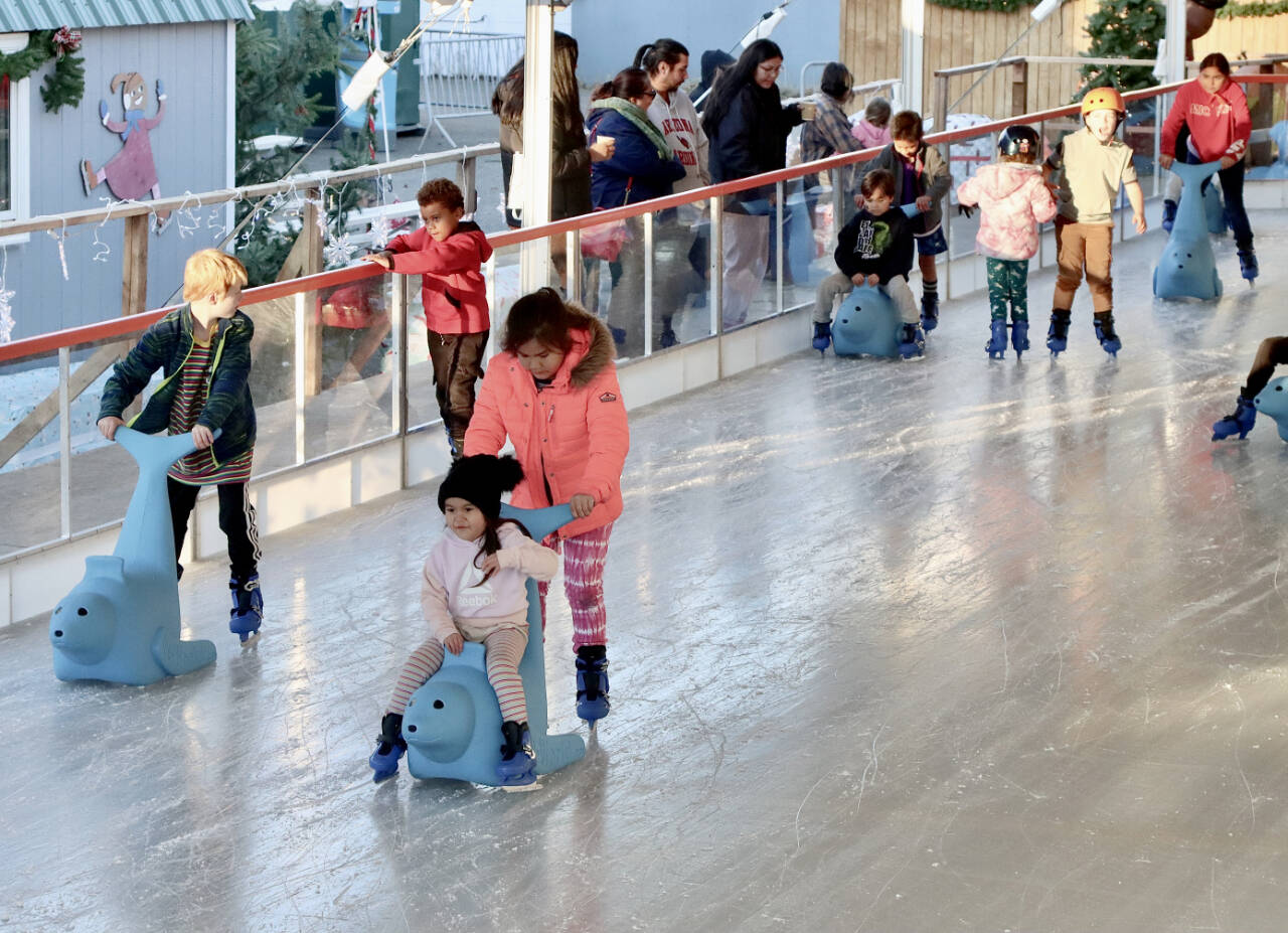 The Winter Ice Village in downtown Port Angeles is open for another season of ice skating. Tiadosa Tom, age 9 in pink, and her cousin Annabella Mason, age 4, are glad the Ice Village finally opened on Friday. (Dave Logan/For Peninsula Daily News)