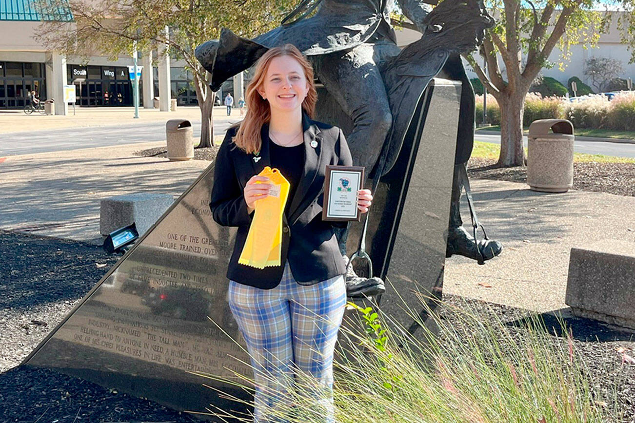 Submitted photo
Neon Riders 4-H Club’s Ruby Coulson stands in front of the renowned Saddlebred Horseman Tom Moore’s statue fresh from her win in the Individual Presentation Contest for her slide-show and speech, “Equine Regenerative Therapies.” at the 4-H National competition in Kentucky.  Billed as the Largest Youth Equine Education Event in North America, it’s a huge accomplishment for the young woman from Sequim.