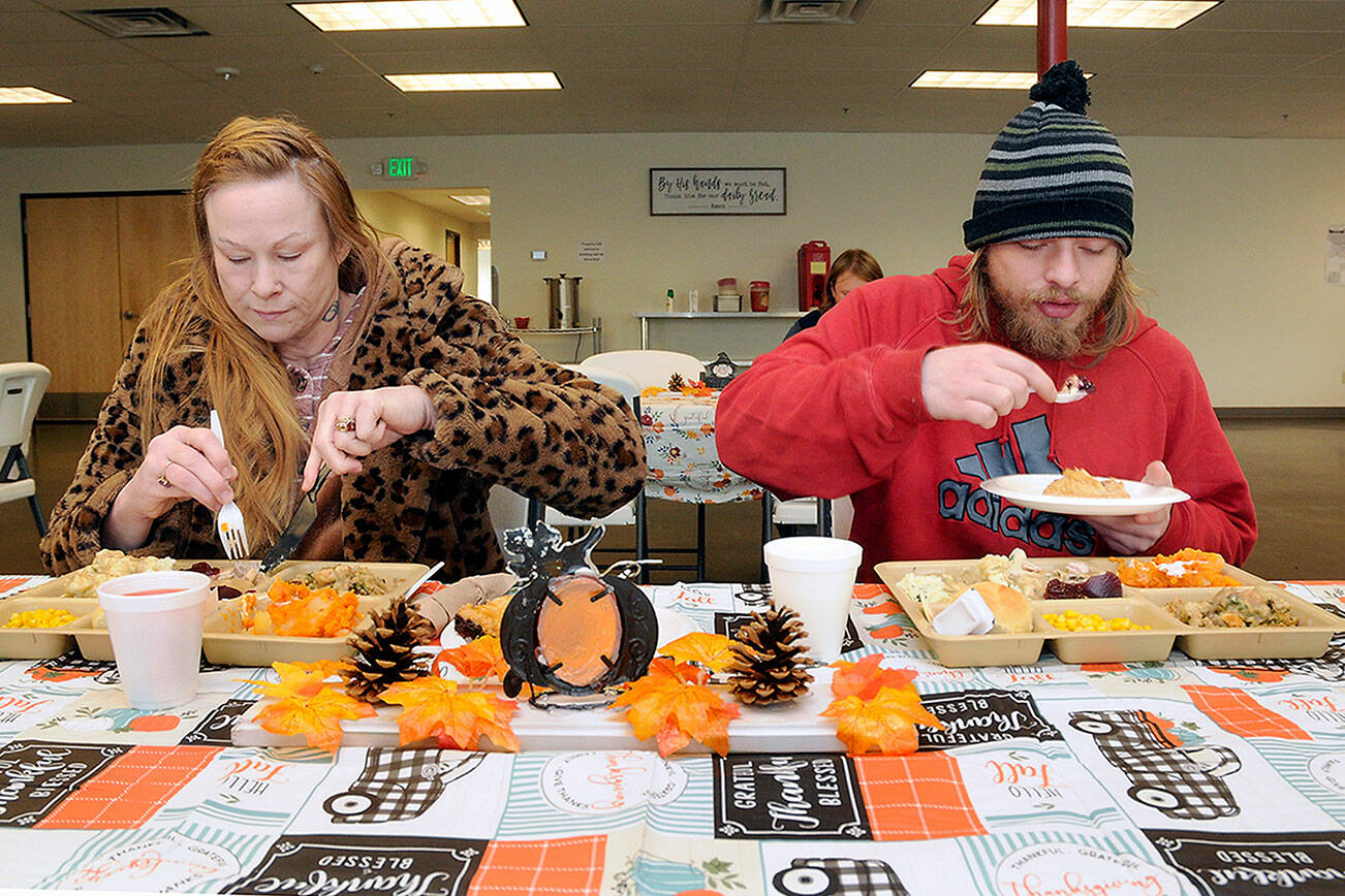 Sena Nucaro, left, and her son, Isaiah Breeden, both of Port Angeles, enjoy a traditional holiday meal during Wednesday’s Thanksgiving Eve lunch at the Port Angeles Salvation Army. (Keith Thorpe/Peninsula Daily News)
