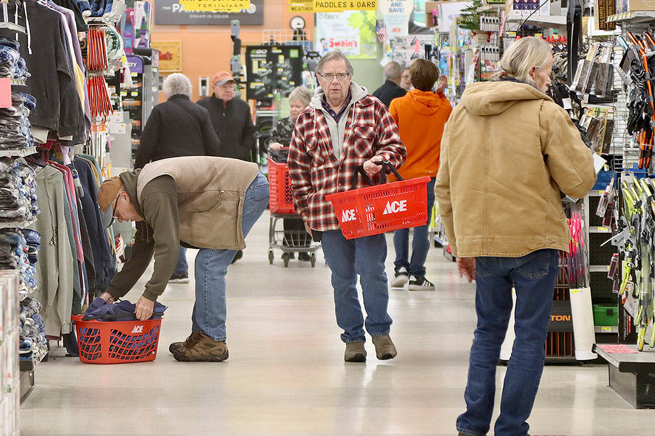 Dave Logan/for Peninsula Daily News
Braving cold steady rain and the early hour of eight Black Friday shoppers were out in force Friday looking for those early holiday bargains. Swain's General Store in Port Angeles was no exception as scores of early risers came out of the cold and rain to shop there.