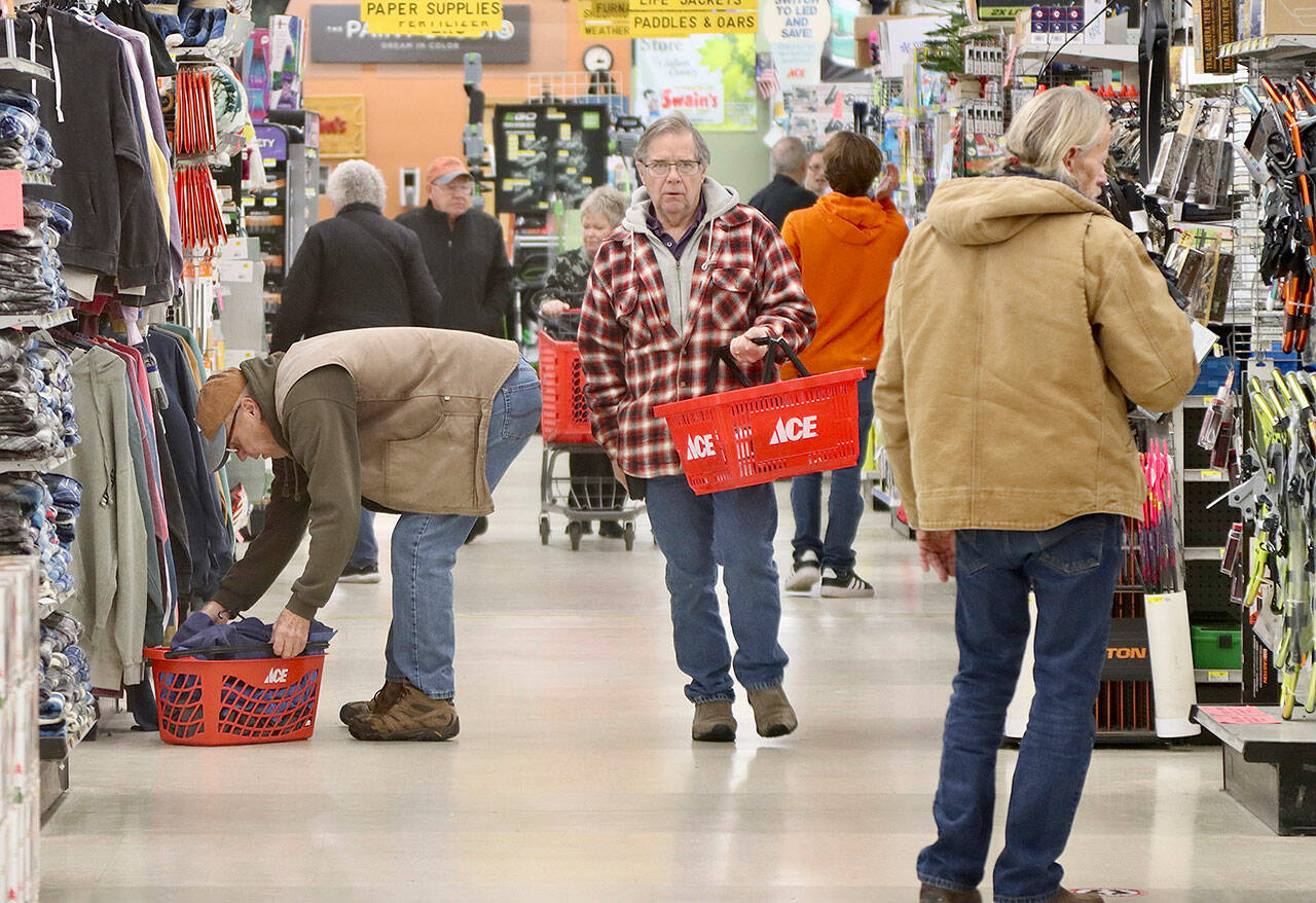 Braving cold steady rain and the early hour of eight Black Friday shoppers were out in force Friday looking for those early holiday bargains. Swain’s General Store in Port Angeles was no exception as scores of early risers came out of the cold and rain to shop there. (Dave Logan/for Peninsula Daily News)