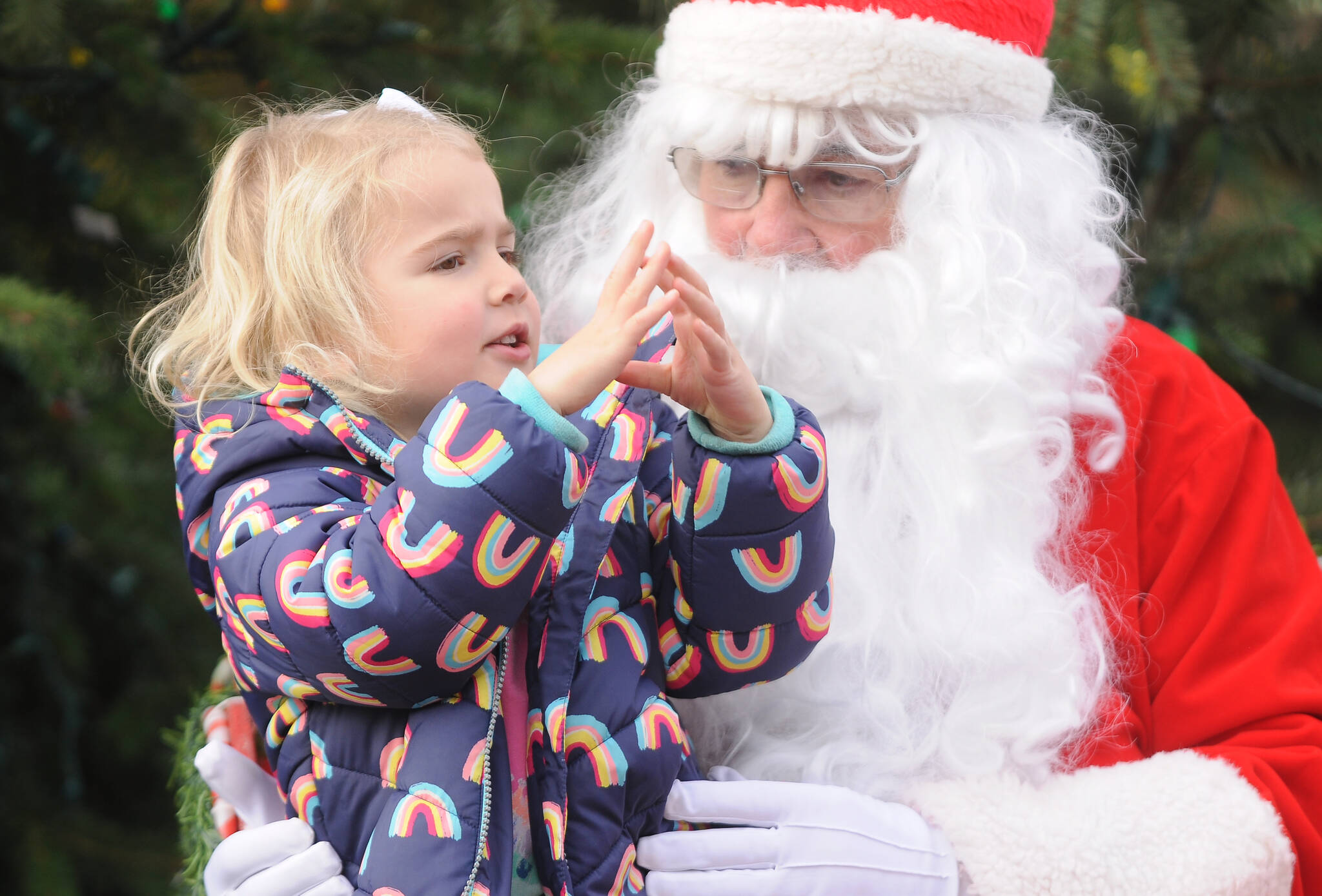 Michael Dashiell / Olympic Peninsula News Group
Finley Loveless, 3, of Sequim spends some quality time with Santa Claus (Stephen Rosales) at the Hometown Holidays event Saturday afternoon in downtown Sequim. Along with photos with Santa and the royalty, other festivities included live music, a tree-lighting ceremony, Sequim Museum & Arts’ Tractor Parade and more.