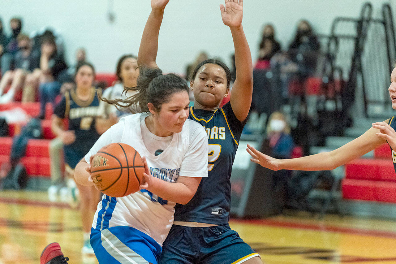 Steve Mullensky/for Peninsula Daily News East Jefferson’s Alyssa Vandenberg drives to the rim while defended by Annie Wright’s Leah Kearns during a December 2021 game played at Port Townsend High School. Vandenberg, a second-team All-Nisqually League selection last season, returns for the Rivals.