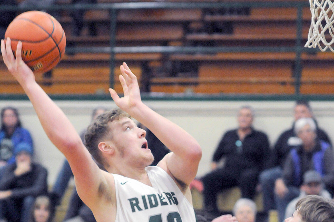 KEITH THORPE/PENINSULA DAILY NEWS
Port Angeles' Isaiah Shamp, left, goes up and over the head of East Jefferson's Stuart Dow on Thursday night in Port Angeles.