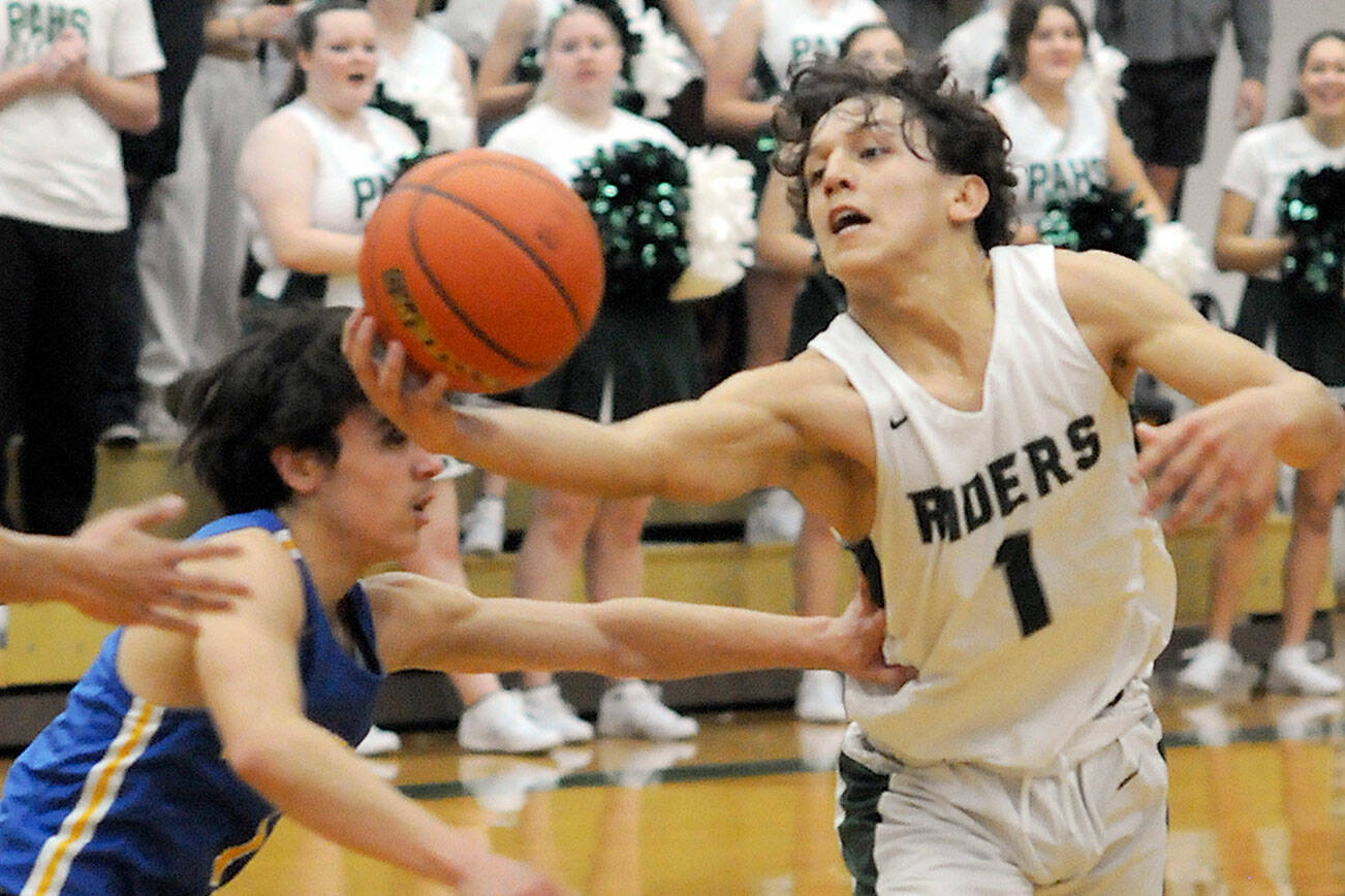 KEITH THORPE/PENINSULA DAILY NEWS
Port Angeles' Kason Albaugh pulls down a loose ball as Bremerton's David Klega, left, tries to push him away during Tuesday's matchup at Port Angeles High School.