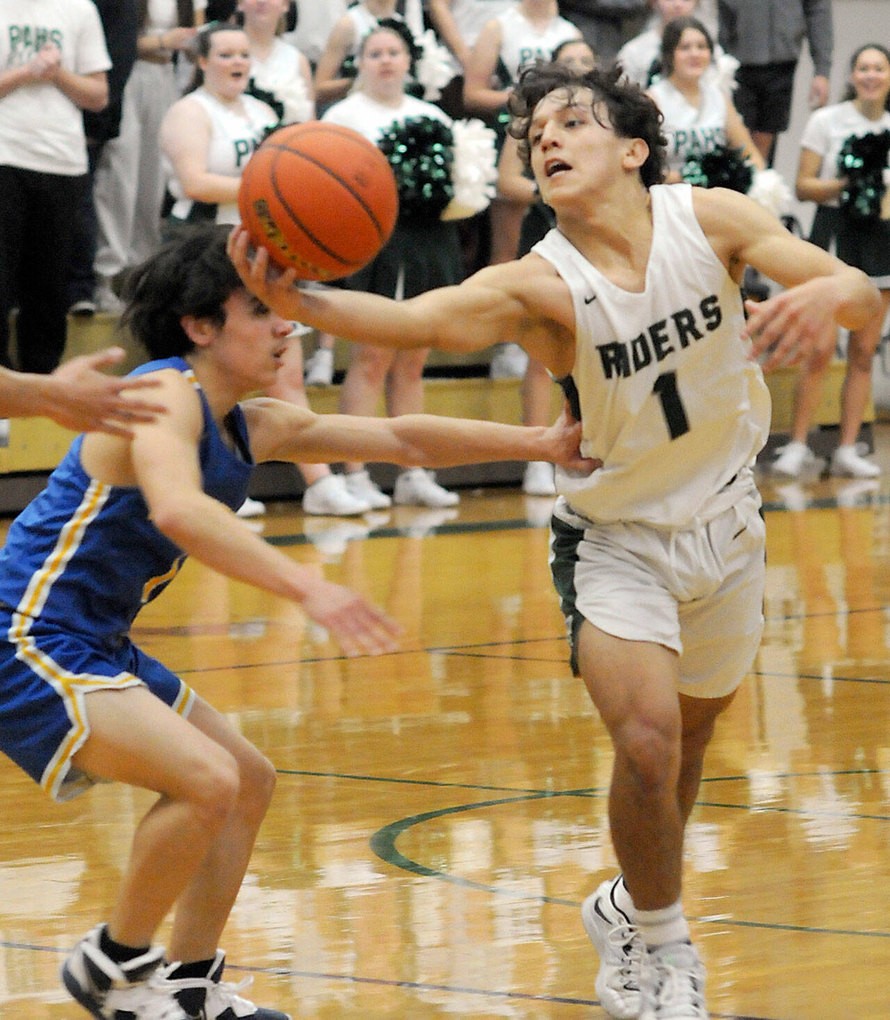 Port Angeles’ Kason Albaugh pulls down a loose ball as Bremerton’s David Klega, left, tries to push him away during Tuesday’s matchup at Port Angeles High School. (Keith Thorpe/Peninsula Daily News)