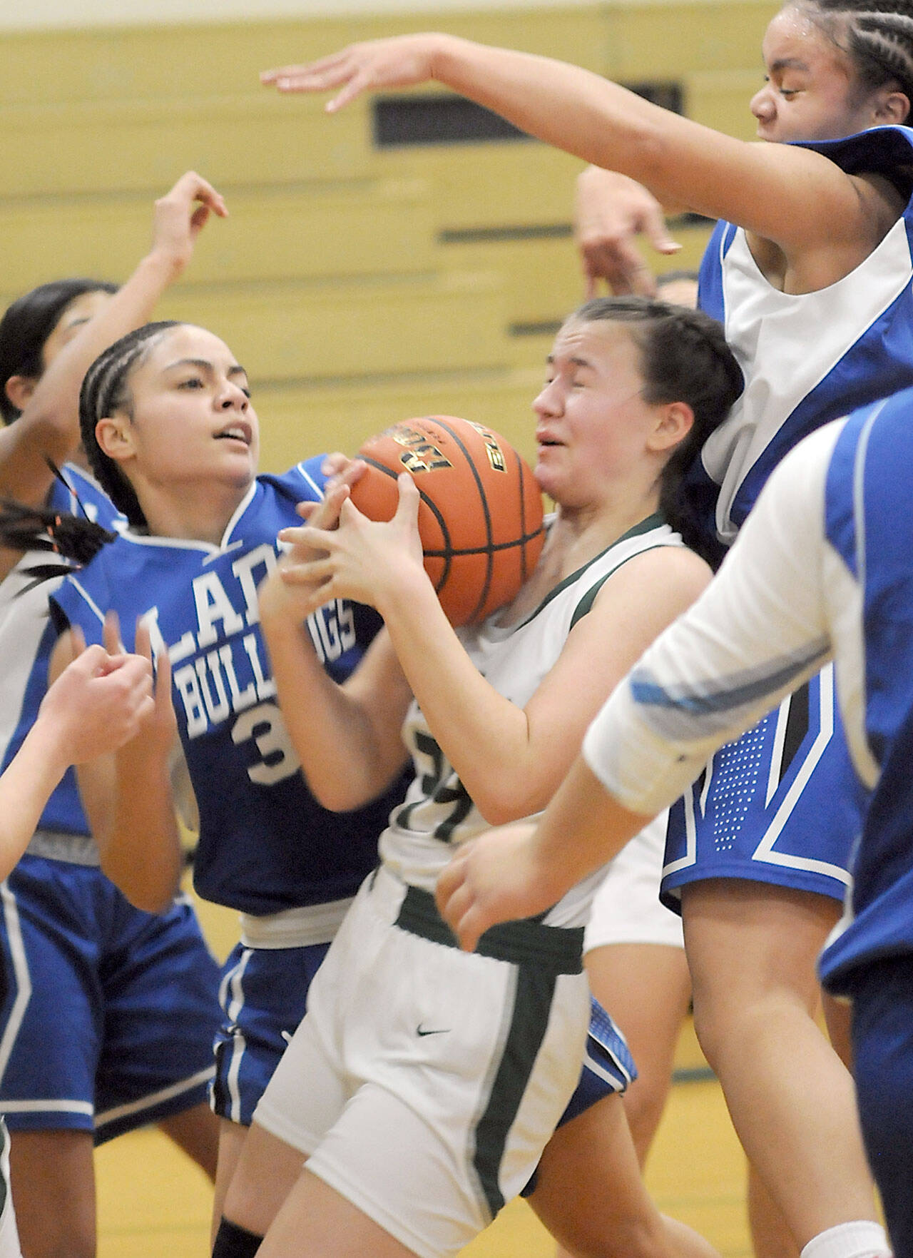 KEITH THORPE/PENINSULA DAILY NEWS Port Angeles’ Lexie Smith, center, is surrounded by North Mason defenders, including Adrianne Tupolo, left, and Adrianna Tupolo, top, during Thursday’s game at Port Angeles High School.